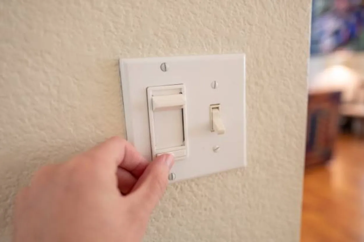 A dimmer switch placed on a wall